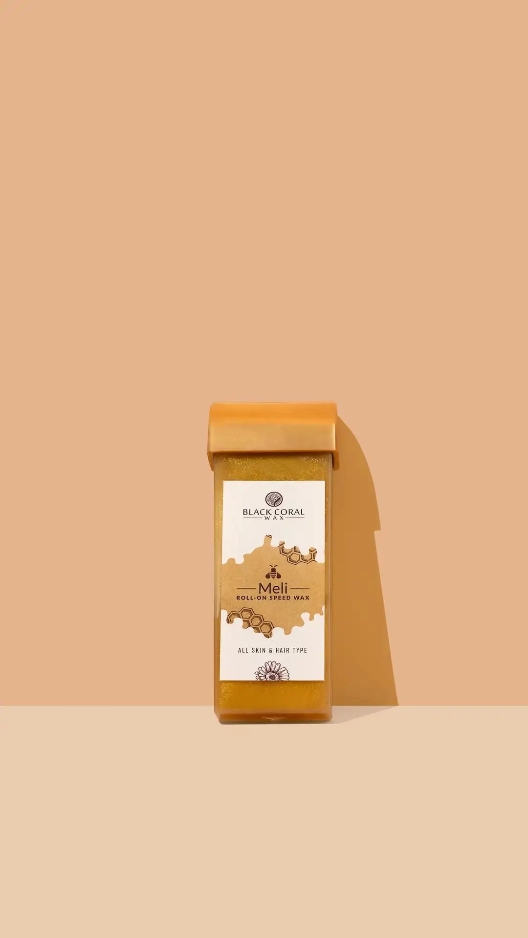 A rectangular wax cartridge labeled Meli Roll-On SpeedWax by Black Coral Wax USA stands upright on a two-tone beige and peach background, emphasizing its gentle waxing benefits as it casts a shadow to the right.