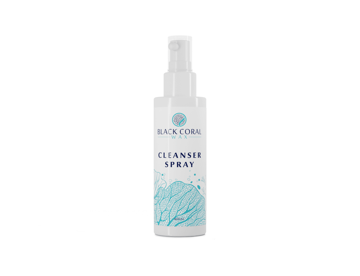 A white bottle of Mae Mae Waxing Kit Cleanser from Black Coral Wax USA, with a blue coral design and labeled Mae Mae Waxing Essentials, is shown on a plain white background for flawless waxing results.