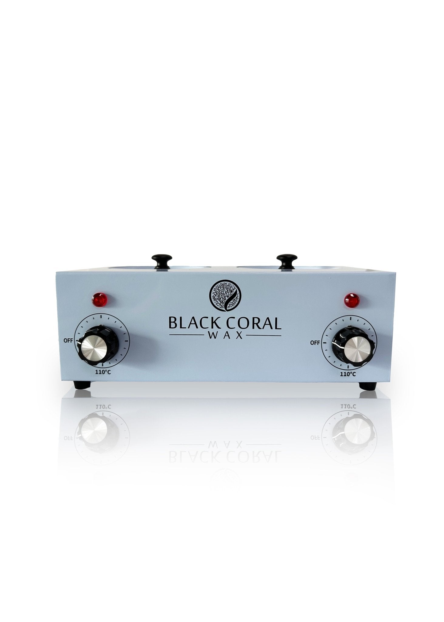 The Black Coral Wax USA Double (2x1lb) Wax Warmer is a rectangular unit with dual temperature control knobs, red indicator lights, and the brand logo on front, shown on a white reflective surface.