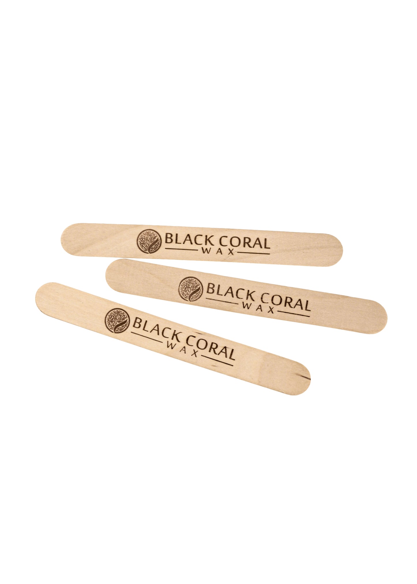 Three Wooden Waxing Sticks from Black Coral Wax USA, perfect for professional use, are displayed diagonally on a white background with Black Coral Wax and a circular logo etched onto each stick.