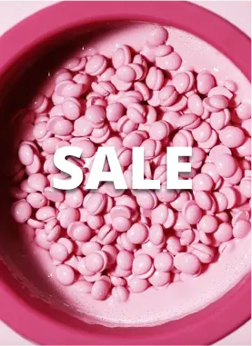 A bowl filled with pink candy-coated chocolates. The word SALE is prominently displayed in white text across the center of the image. The bowl has a pink rim, matching the color of the candies.