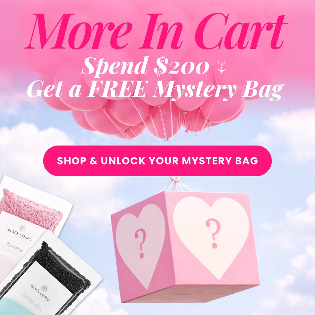 A pink and white gift box with heart and question mark symbols floats on pink balloons. Text offers a free Black Coral Wax USA Mystery Box with a $200 purchase. Two waxing product bags appear at the bottom.
