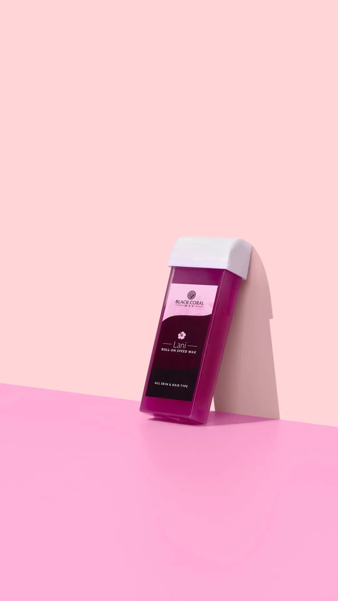A rectangular Lani Roll-On SpeedWax cartridge by Black Coral Wax USA stands upright against a pink background with a soft shadow.
