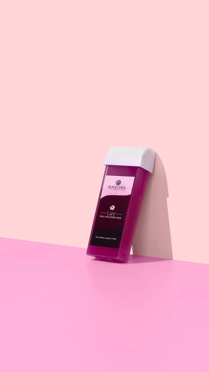 A rectangular Lani Roll-On SpeedWax cartridge by Black Coral Wax USA stands upright against a pink background with a soft shadow.
