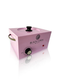 The Black Coral Wax USA 5lb Warmer + FREE Hard Wax features a pink body with a black knob, temperature dial, side handle, clear lid, red indicator light, and the logo on front. Shown on a white background.