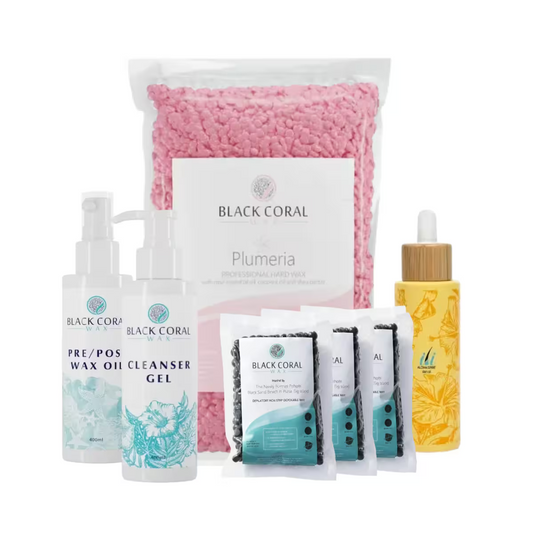 The Face Expert Kit by Black Coral Wax USA includes a large bag of pink wax beads, two pump bottles, a dropper bottle with yellow liquid, and four small packets, each with distinct labels and designs.