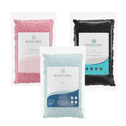 Three clear bags of Brazilian Pro Waxing Kit hard wax beads in pink, black, and light blue—ideal for intimate waxing—stand upright on a white background, each labeled with Black Coral Wax USA branding and product details.