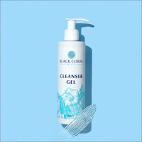 A 400ml bottle of Black Coral Wax USA Cleanser Gel with a pump top, featuring a blue floral design, sits on a light blue background alongside a smear of clear gel—ideal for pre-waxing cleansing routines or as part of your post-waxing care.