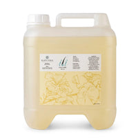 A translucent plastic jug with a handle contains a yellow liquid labeled “ili Oil 60ml Ingrown Oil” by Black Coral Wax USA. Perfect for use as an ingrown skin oil or post-waxing oil, it moisturizes the skin for a smooth, nourished feel. The label displays floral line art along with product details.