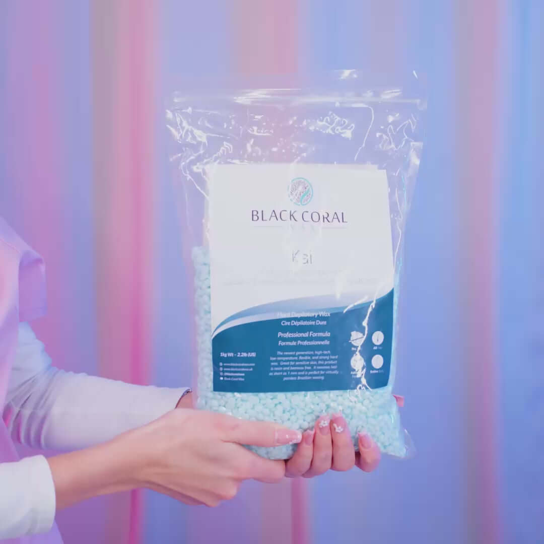 Bag of Black Coral Wax USA Kai Hard Wax beads in vibrant turquoise tones, shown in detail with the product packaging and logo clearly visible.