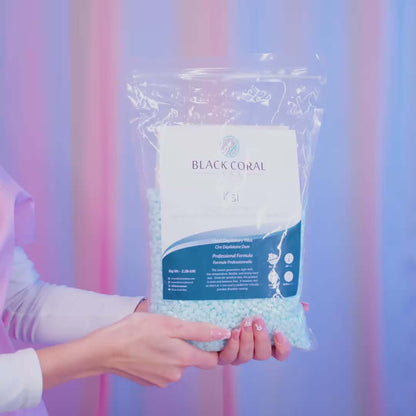 Bag of Black Coral Wax USA Kai Hard Wax beads in vibrant turquoise tones, shown in detail with the product packaging and logo clearly visible.
