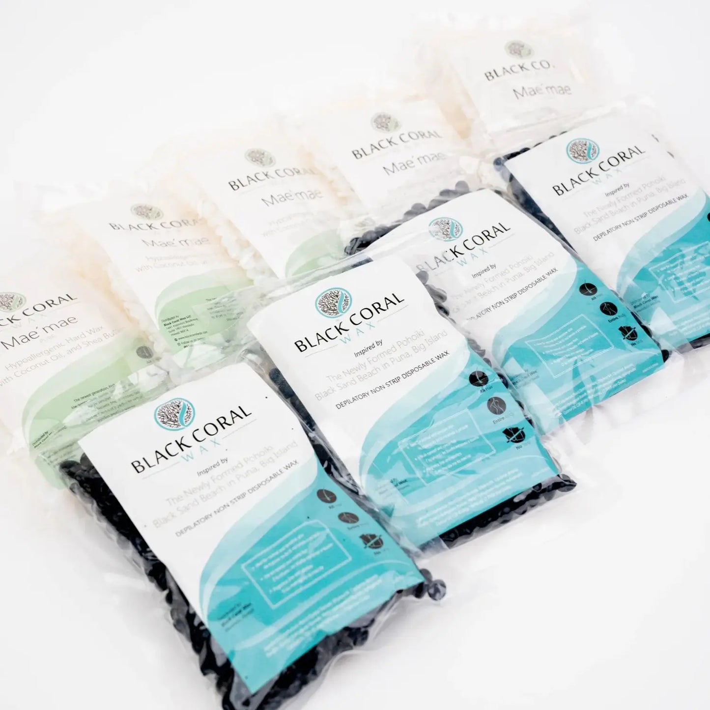 Compact Hard Wax Sample Bags by Black Coral Wax USA neatly arranged in two rows reveal the sleek design through transparent packaging, featuring a prominent logo and detailed product information akin to Mae Mae Hard Wax Beans.